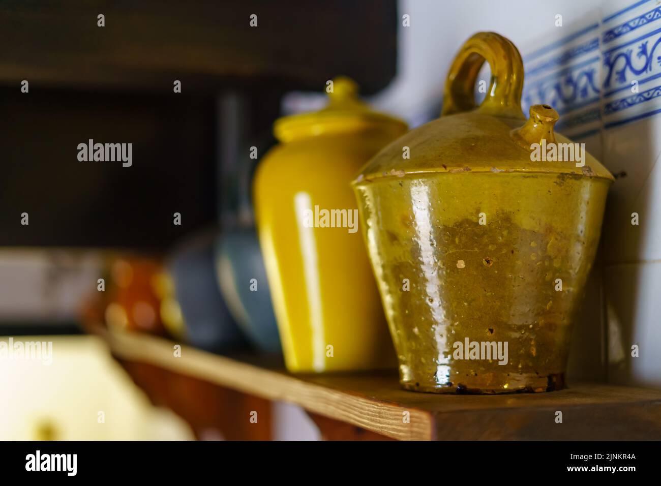 Contenitori in argilla e ceramica su scaffali con un aspetto generale vintage. Foto Stock