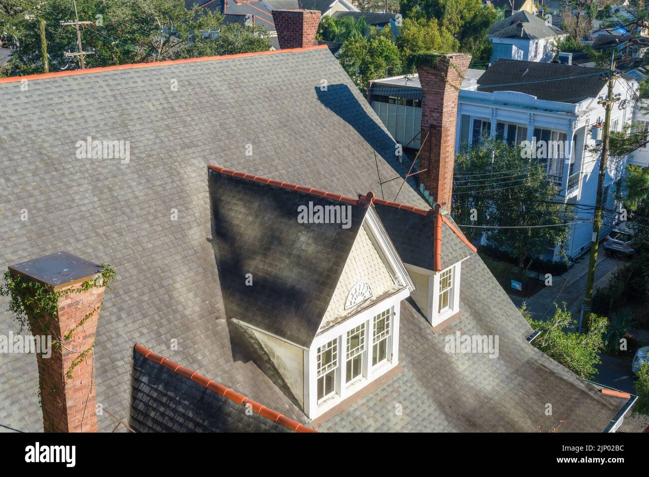 NEW ORLEANS, LA, USA - 13 GENNAIO 2022: Veduta aerea del tetto della storica casa del Garden District che mostra il tetto inclinato, i camini d'epoca e la finestra Foto Stock