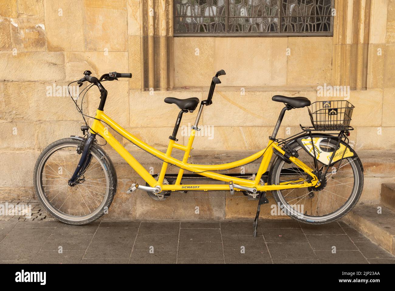 Muenster, Germania, 9 luglio 2022 la bicicletta tandem gialla è appoggiata su un muro nel centro della città Foto Stock