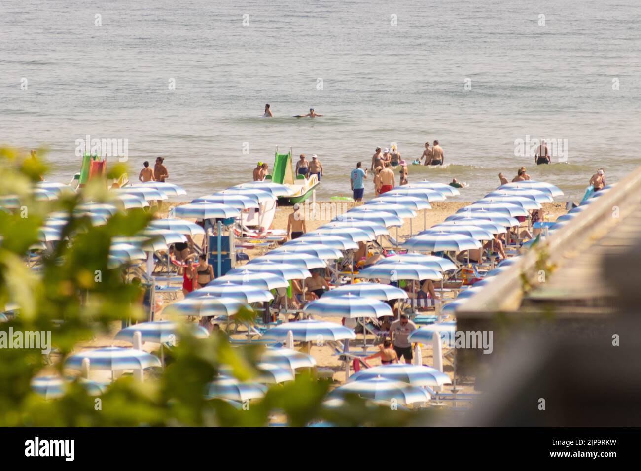 Spiaggia con bagnanti in estate. Rimini, Italia Foto Stock