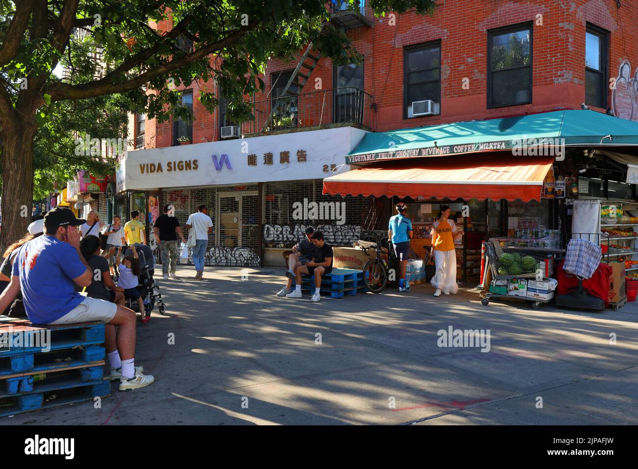 Le persone in attesa di ordini di bevande presso L'A & N Fruit Store, 25 Canal St, New York, a Chinatown 'Dimes Square' di Manhattan/Lower East Side. Foto Stock