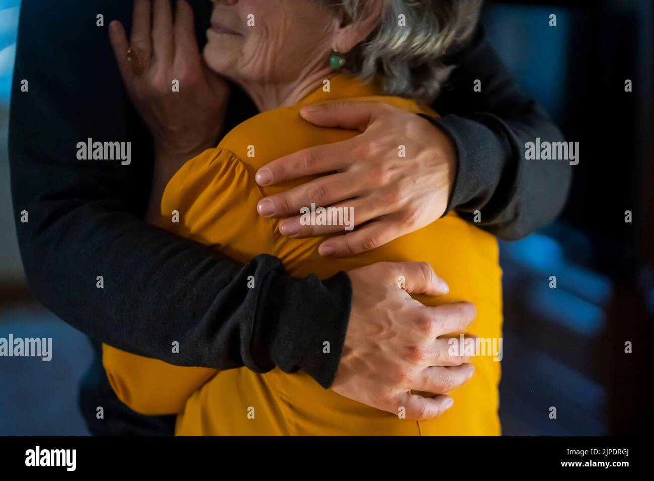 L'uomo sostiene la sua vecchia nonna, le tiene le mani. Foto Stock