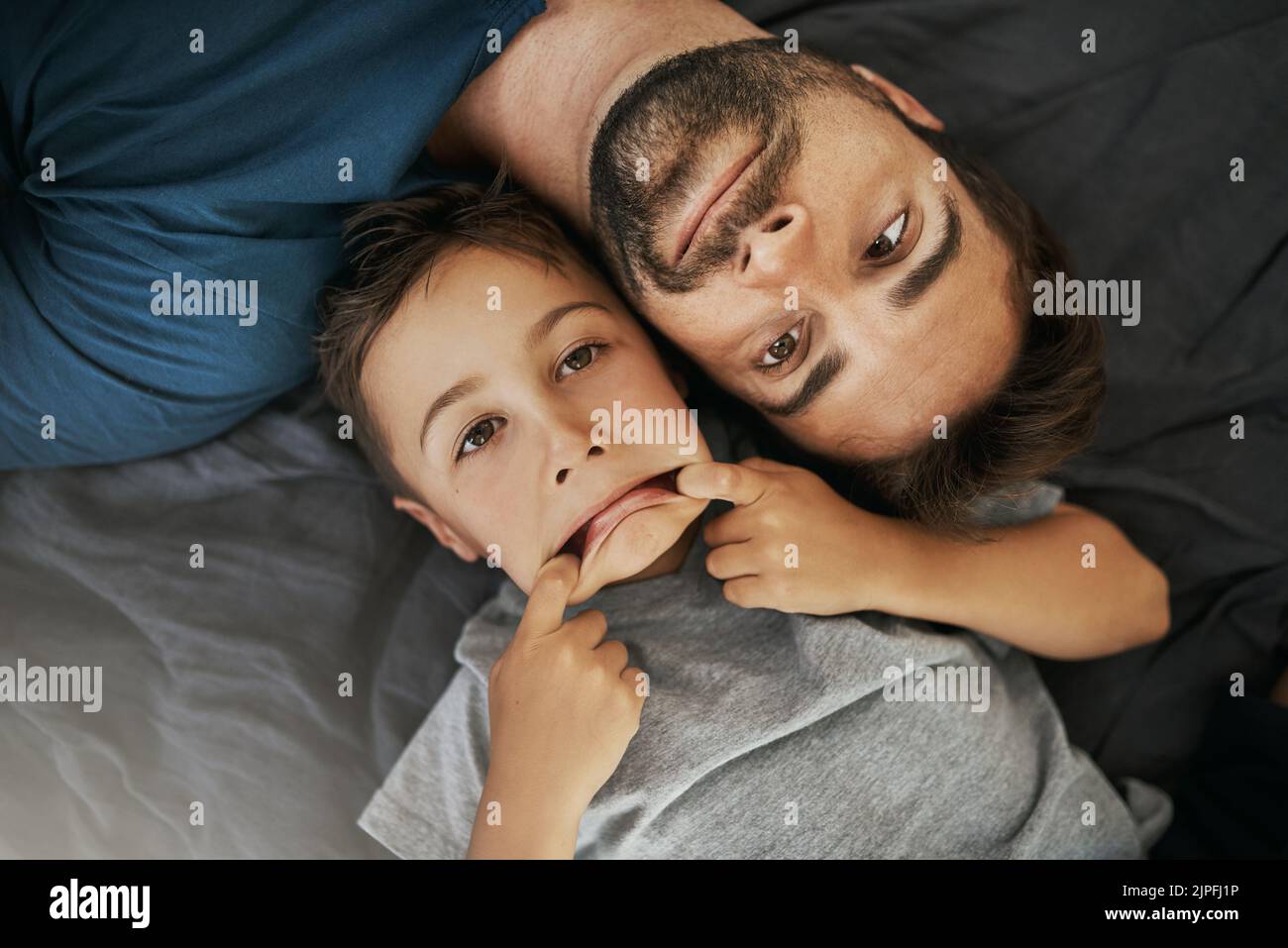 Non facciamo del tutto normale, il giovane ragazzo e suo padre si legano a casa. Foto Stock