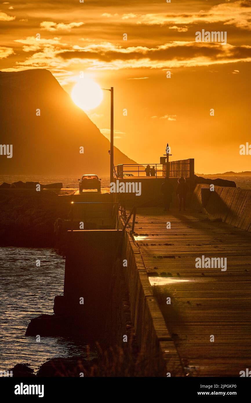 Passeggiata al tramonto sul molo di Flø, Ulsteinvik, Norvegia. Foto Stock