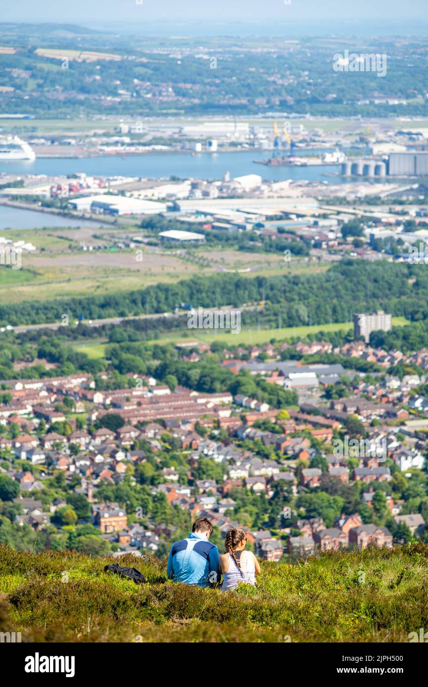 Una coppia seduta a Cave Hill ammirando la vista di Belfast in Irlanda del Nord, Regno Unito Foto Stock