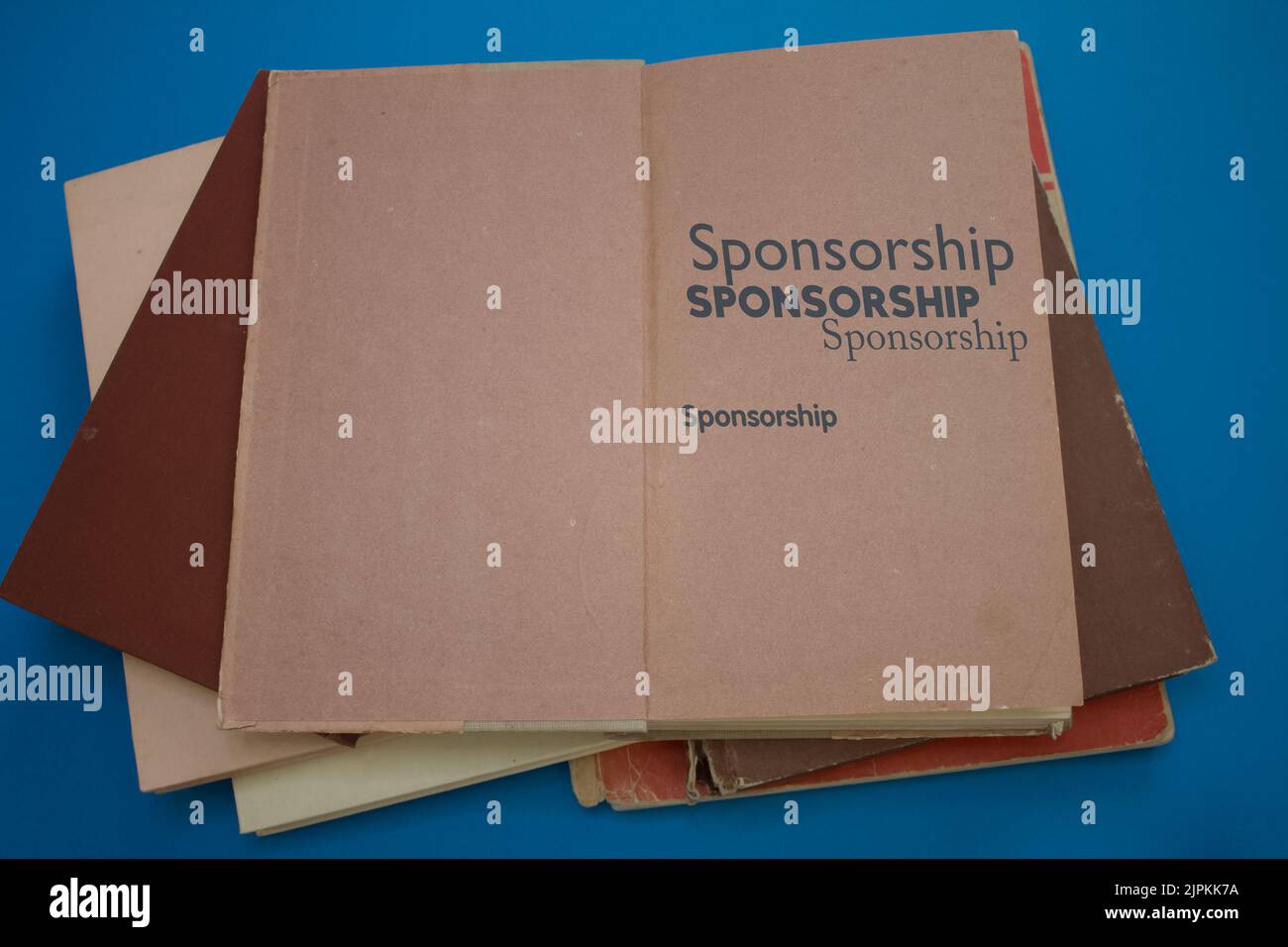 Parola di sponsorizzazione in libro aperto con vintage, motivi naturali vecchio disegno di carta antica. Foto Stock