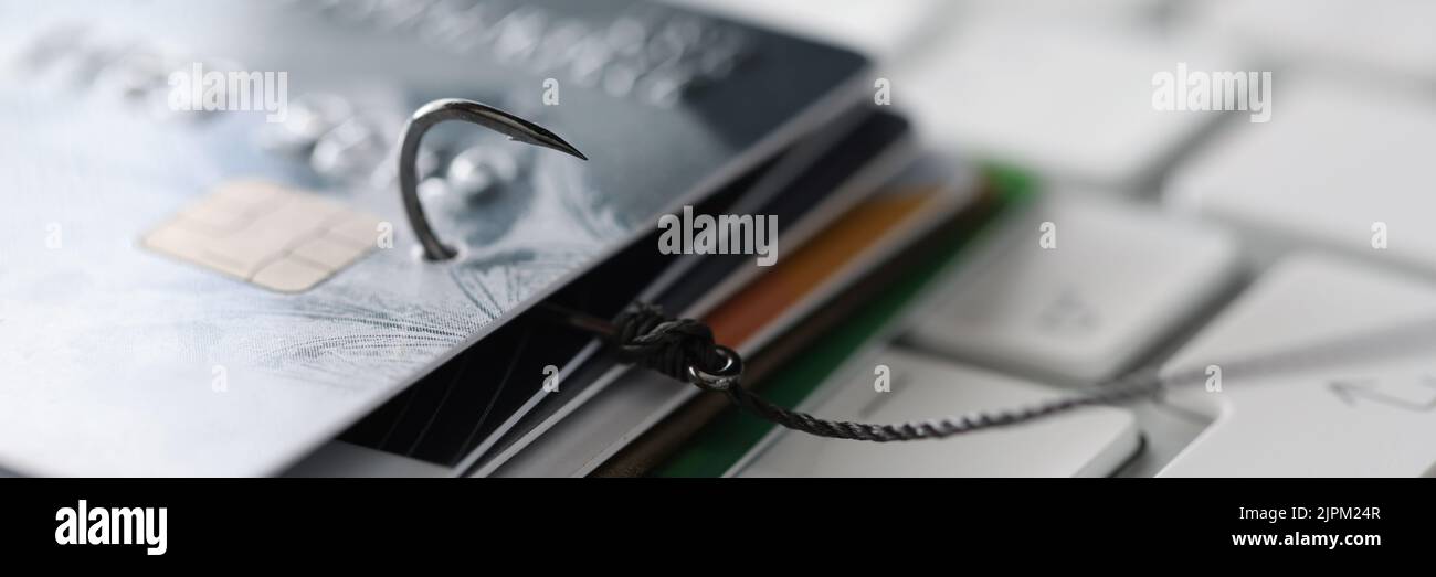 Gancio da pesca con carte di credito sul primo piano della tastiera Foto Stock
