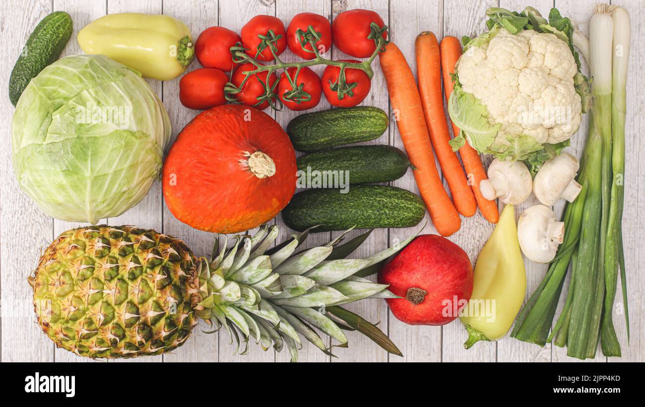 Frutta e verdura su sfondo di legno. Piatto laici concetto di cibo sano Foto Stock