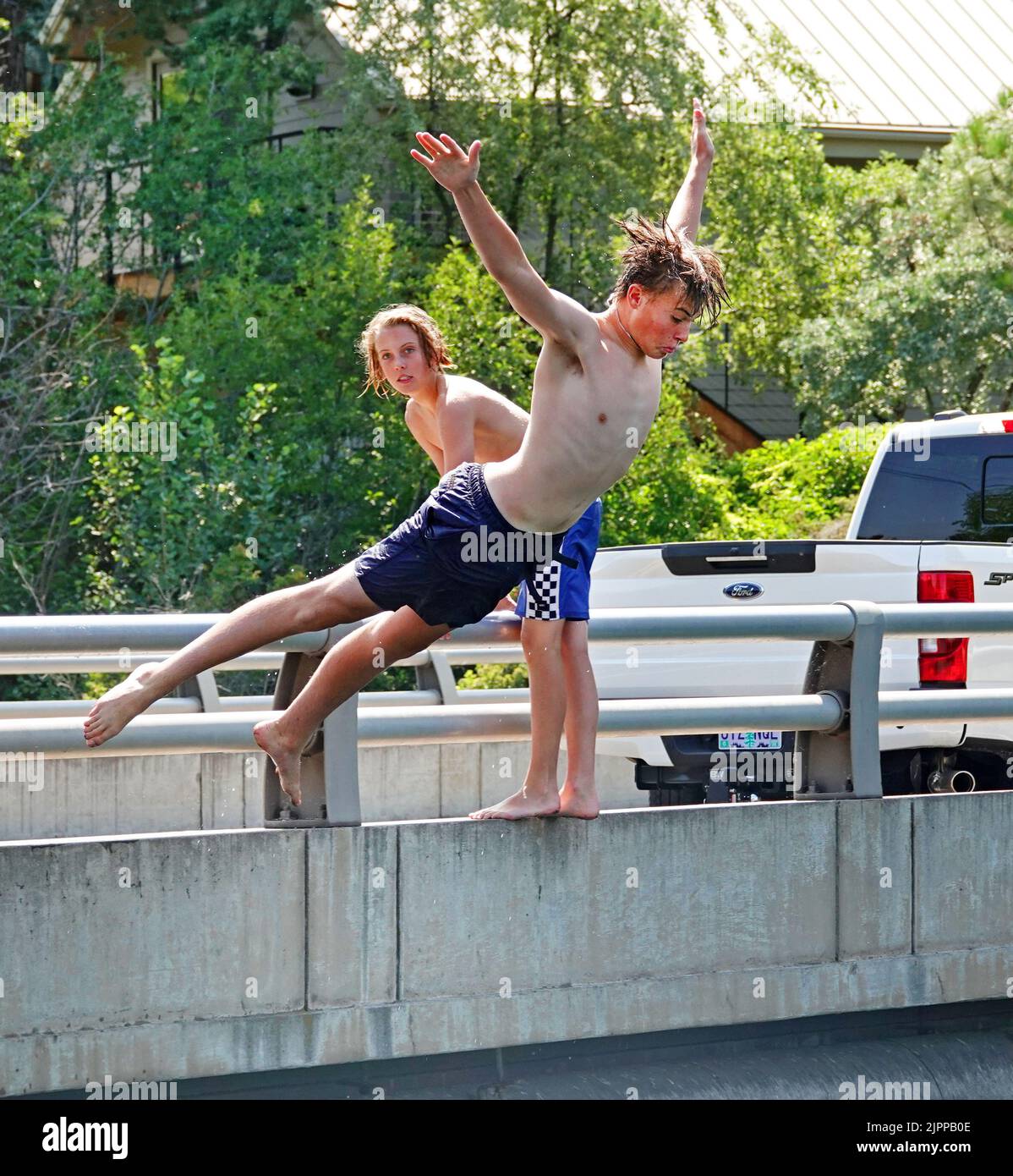 I ragazzi si rinfrescano immergendosi nel fiume Deschutes di Bend, Oregon, cercando di sfuggire all'onda di calore a 100 gradi che sta spazzando via il Pacifico nord-occidentale. Foto Stock