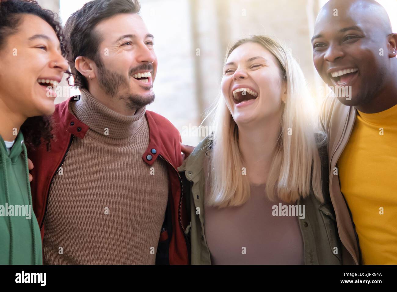 Gruppo multirazziale di amici che si divertono insieme fuori - gente milleniale ridere abbracciando alla festa - concetto di amicizia con ragazzi e ragazze fuori Foto Stock