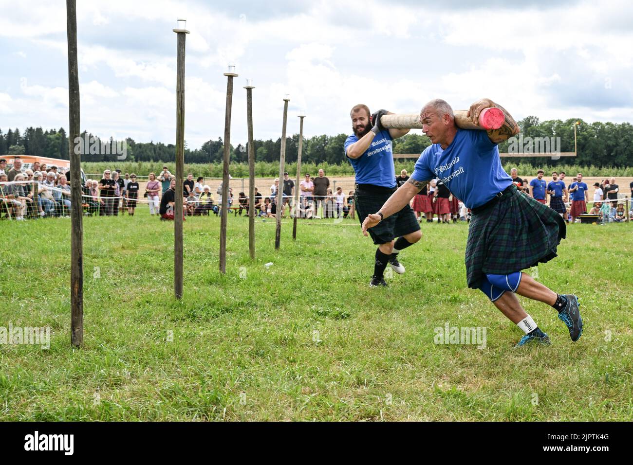 Wilhelmskirch, Germania. 20th ago, 2022. Jonas Horn e Franz Ritzer (r) del Team o'Balandla Bruderschaft corrono attraverso un percorso slalom con un fascio sulle spalle al 'Oberschwäbische Highländgames'. Squadre provenienti da tutta la Germania meridionale si sono incontrate per mettere alla prova la loro abilità durante le partite. Credit: Felix Kästle/dpa/Alamy Live News Foto Stock