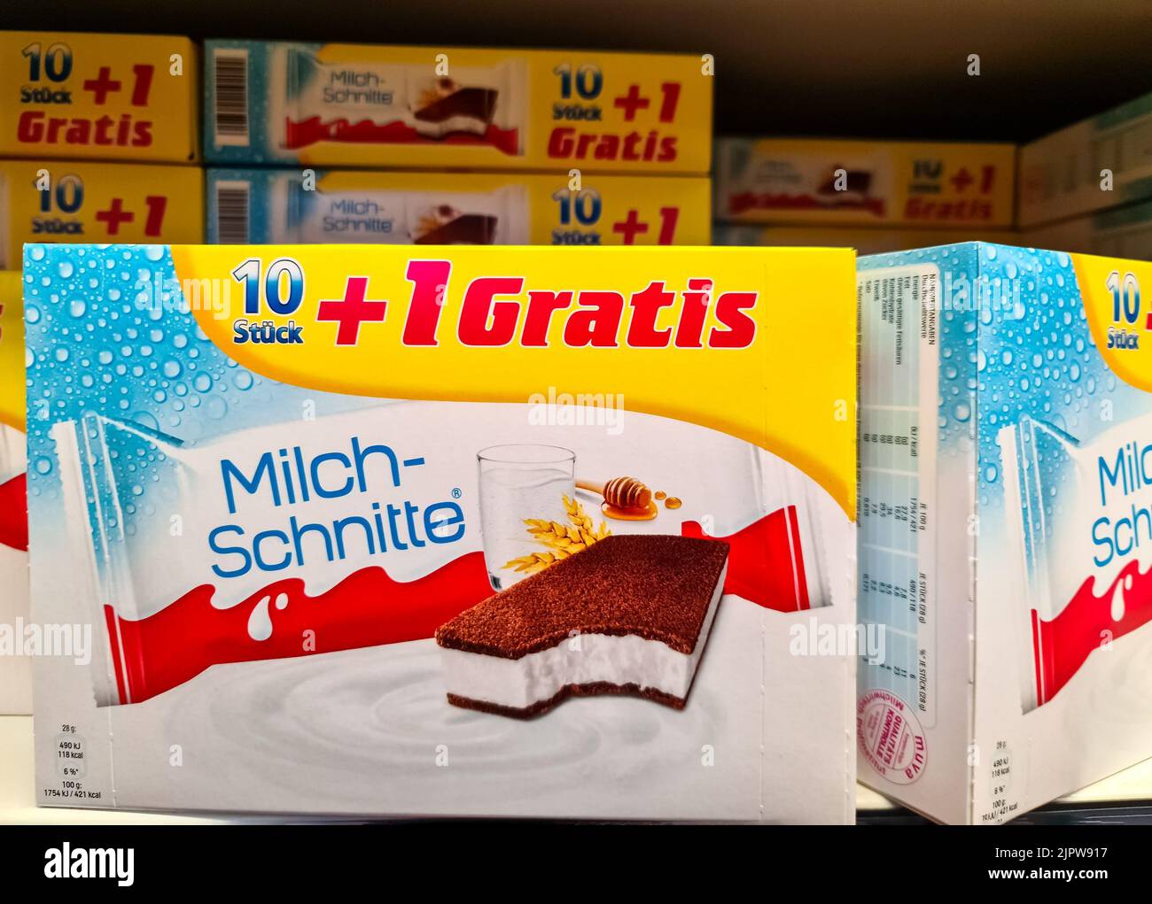 Un primo piano di cartoni di dolci del marchio Milchschnitte per bambini su uno scaffale del supermercato Foto Stock