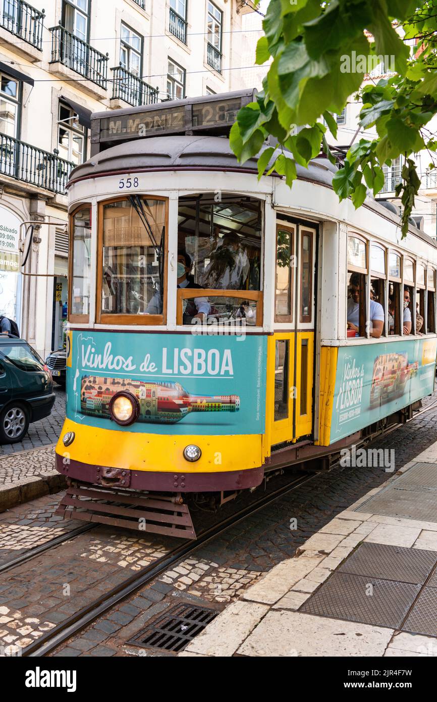 I famosi tram di Lisbona mentre si spostano attraverso la vecchia strada di Lisbona Foto Stock
