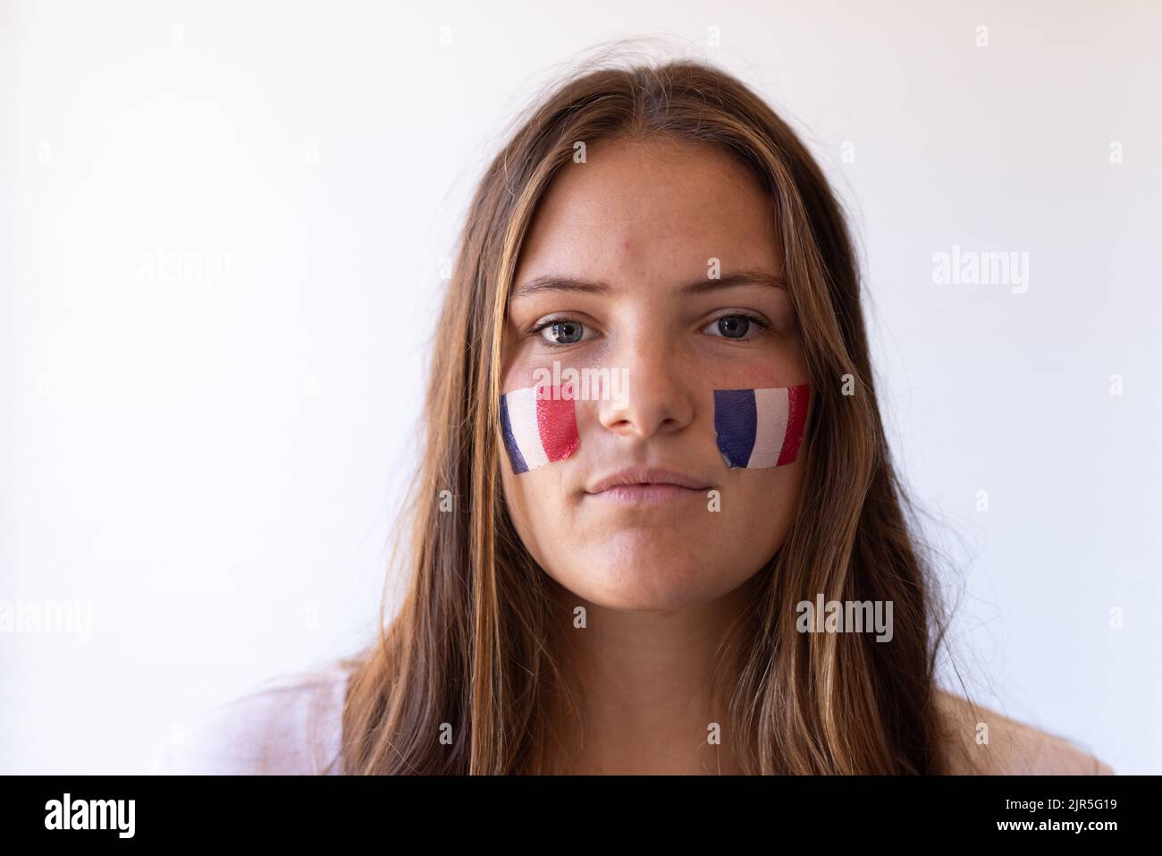 Immagine di una grave donna caucasica con bandiere di francia in faccia Foto Stock