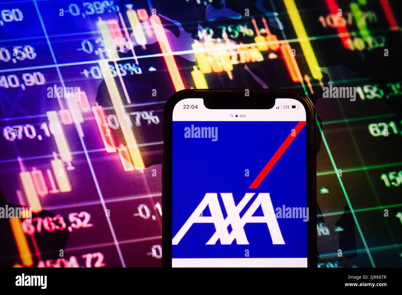 KONSKIE, POLONIA - 10 agosto 2022: Smartphone che mostra il logo della società AXA sullo sfondo del diagramma di borsa Foto Stock
