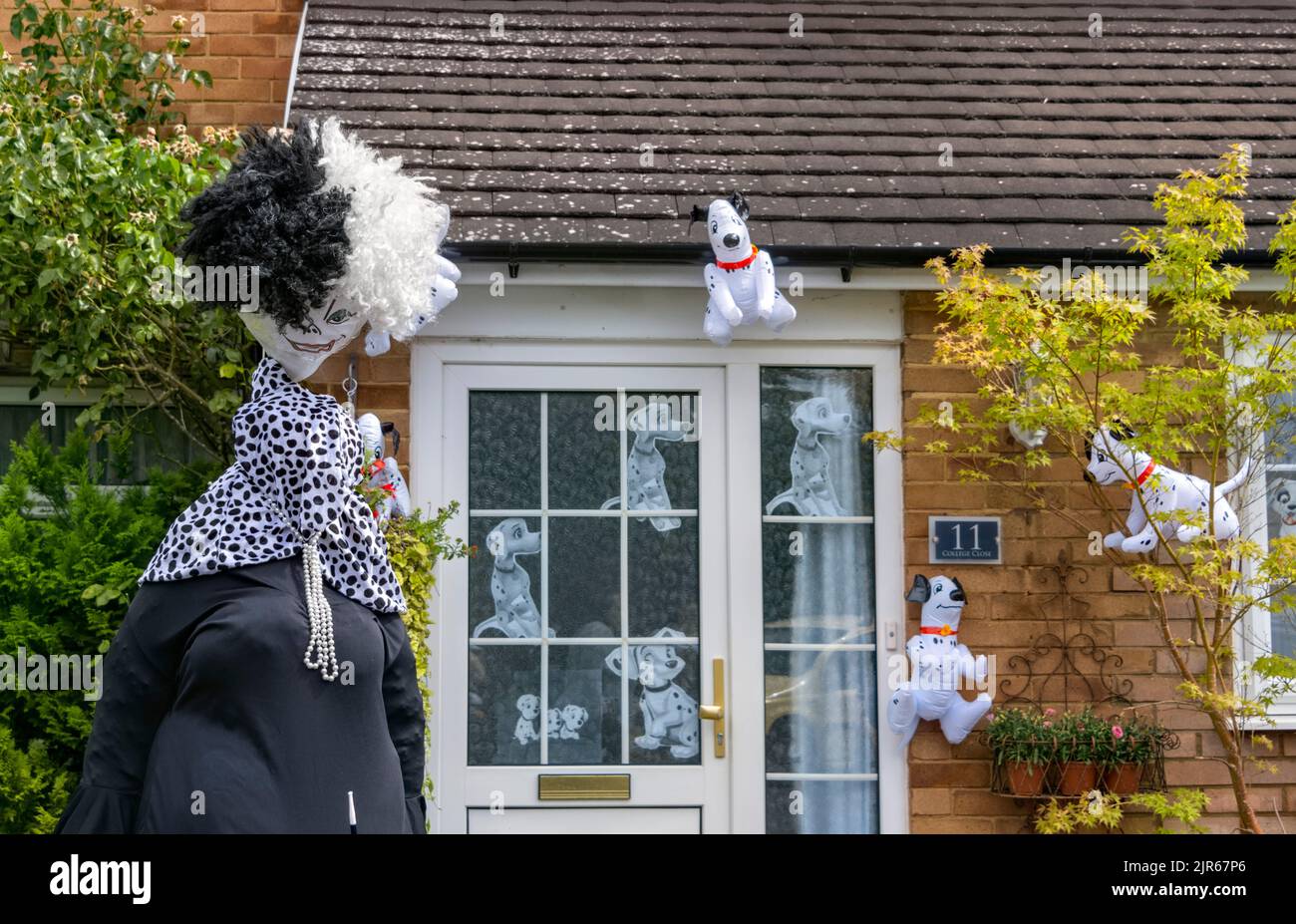 Flamstead Scarecrow Festival 2022 - Cruella de Vil e 101 Dalmatations Scarecrow e cani dalmati lamina decorare l'esterno di una casa, Flamstead. Foto Stock