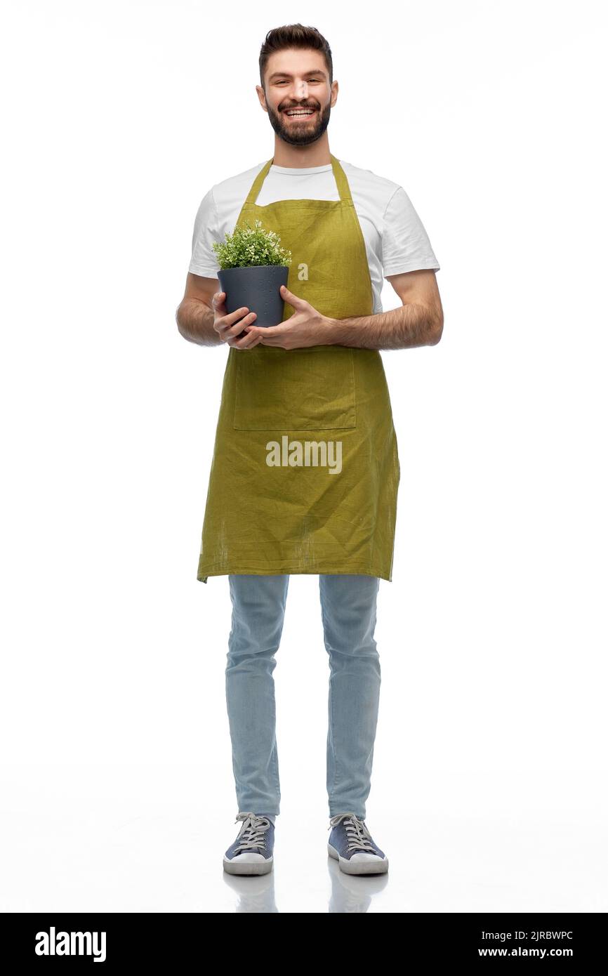 felice sorridente giardiniere maschio con fiore in vaso Foto Stock