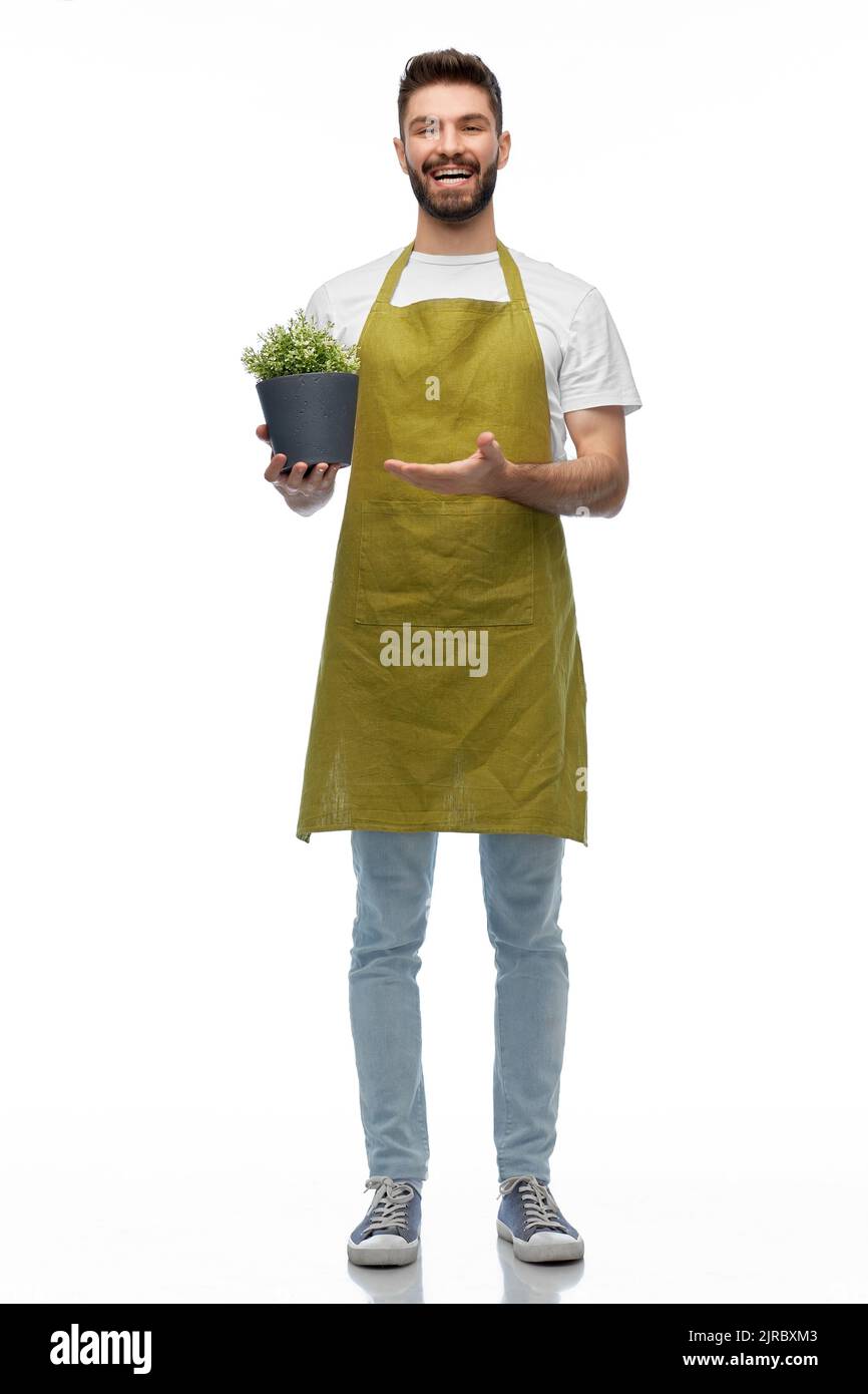 felice sorridente giardiniere maschio con fiore in vaso Foto Stock