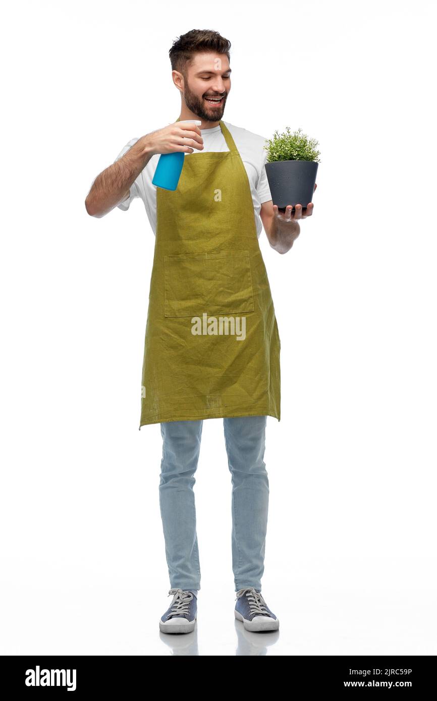 felice sorridente maschio giardiniere moisturizing fiore Foto Stock