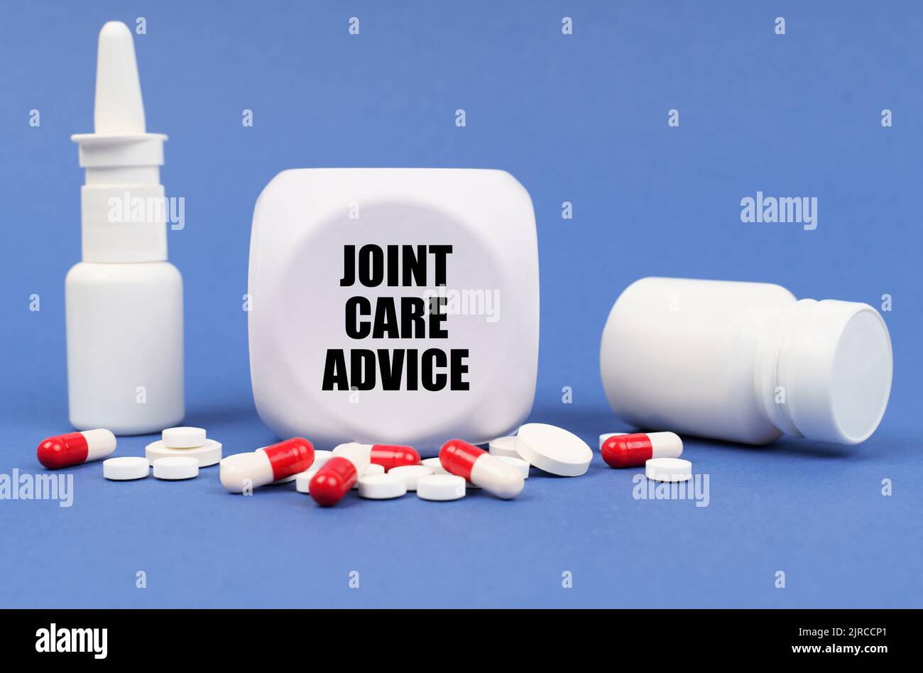 Concetto medico. Sulla superficie blu della pillola, capsula, spray, vaso e cubo con l'iscrizione - consigli per la cura delle articolazioni Foto Stock