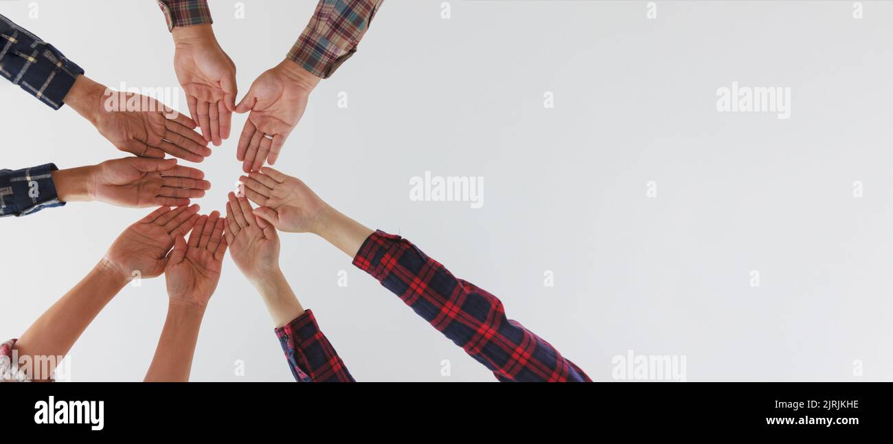 Un gruppo eterogeneo di persone collega le mani come un segno di sostegno che esprime un senso di lavoro di squadra. Unità e togetherness.Copy spazio. Foto Stock