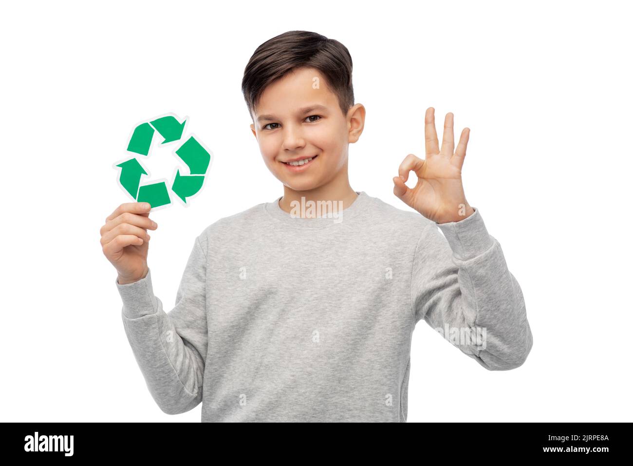 ragazzo felice che tiene il segno verde di riciclaggio mostrando ok Foto Stock