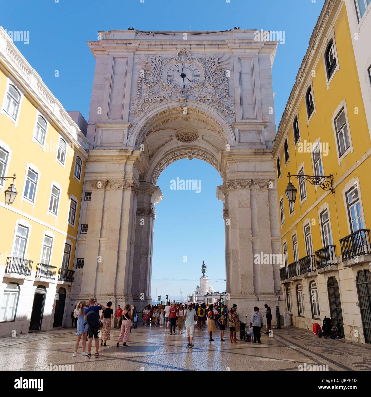 Rua Augusta Arch con il suo orologio da strada Rua Augusta pieno di turisti, con Praca Commercial (Piazza commerciale) dietro. Lisbona, Portogallo. Foto Stock