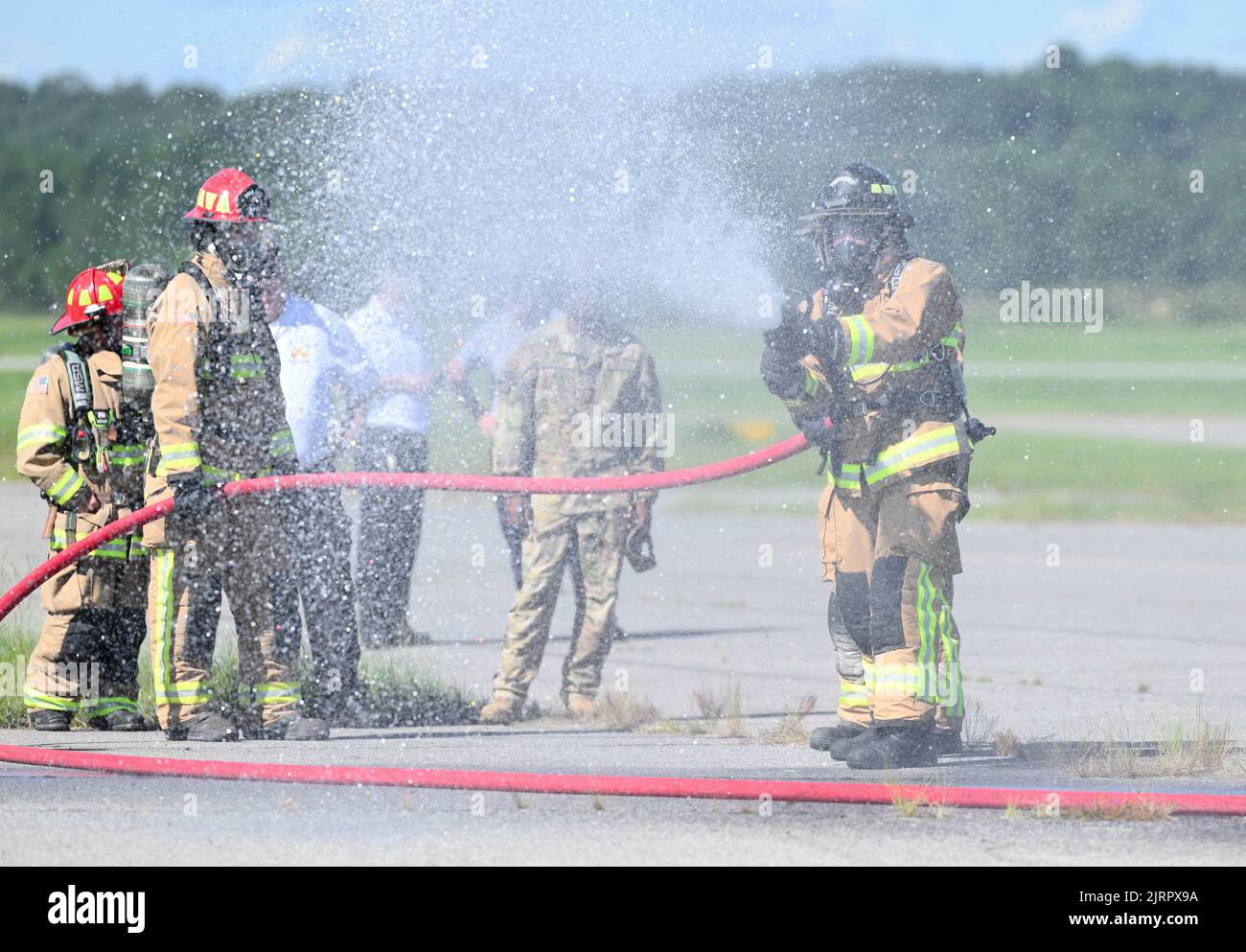 I vigili del fuoco dell'aeronautica degli Stati Uniti dello Squadron 908th dell'ingegnere civile testano vari modelli di flusso dall'ugello della manichetta antincendio durante un esercizio di addestramento congiunto di interoperabilità, 4 agosto 2022, a Fort Benning, Georgia. L'esercizio di addestramento è stato un'opportunità unica per i vigili del fuoco 908th CES di utilizzare un addestratore di elicotteri per prepararsi alla nuova missione di elicottero MH-139A Grey Wing del 908th Airlift Wing, soddisfacendo al contempo i loro requisiti annuali. (STATI UNITI Air Force foto di Airman 1st Class Juliana Todd) Foto Stock