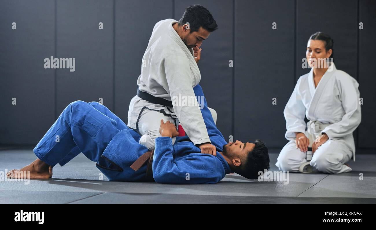 Esercizio, apprendimento e formazione degli studenti di Karate con mma coach, insegnamento, sport e allenamento in palestra. L'atleta del benessere, dello sport e del fitness prende il completo Foto Stock