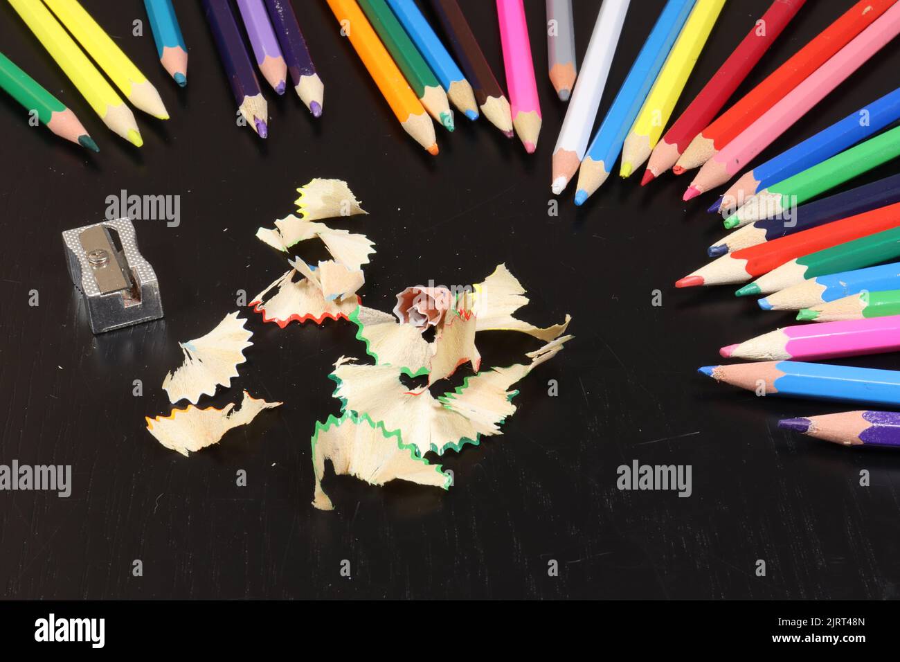 Matita colorata su un tavolo di legno nero Foto Stock