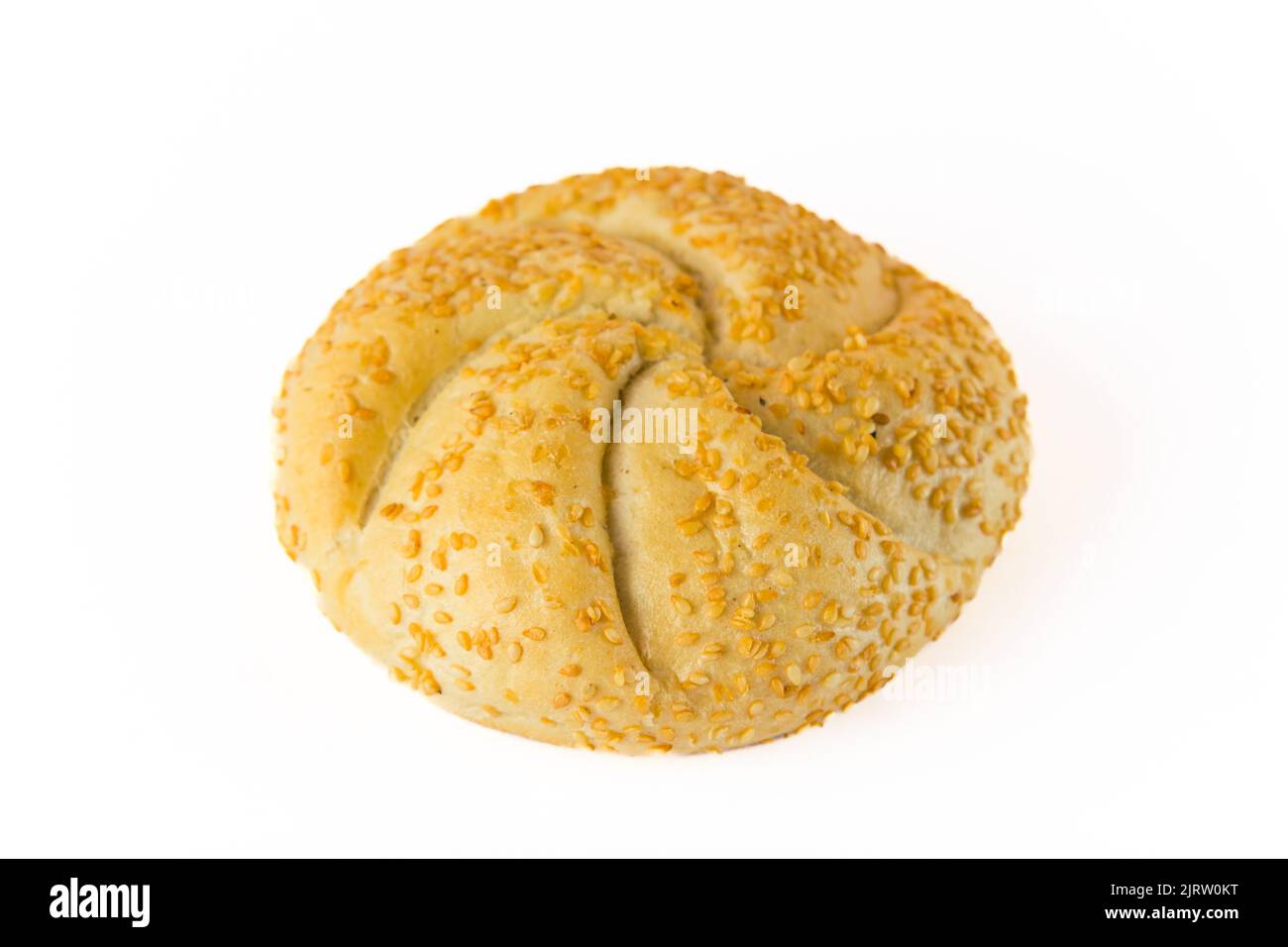 Variante di un tradizionale rotolo kaiser. Rotolo di pane singolo rotondo con guarnizione di semi di sesamo tostata isolata su sfondo bianco. Gustosa colazione. Foto di alta qualità Foto Stock