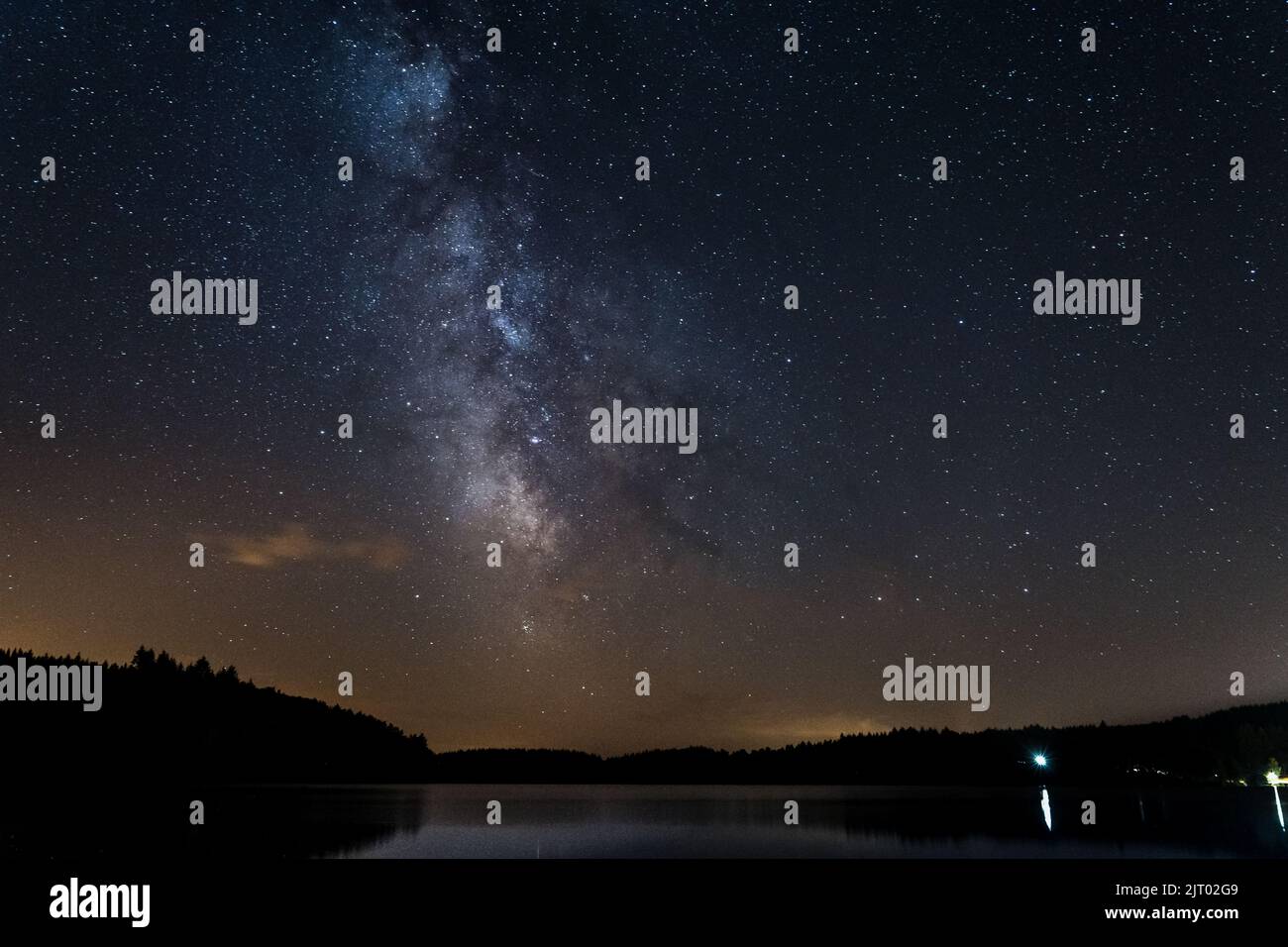 Via Lattea e stelle sopra il lago Neuvic a Correze, Francia, Limousin, durante l'estate 2021 Foto Stock