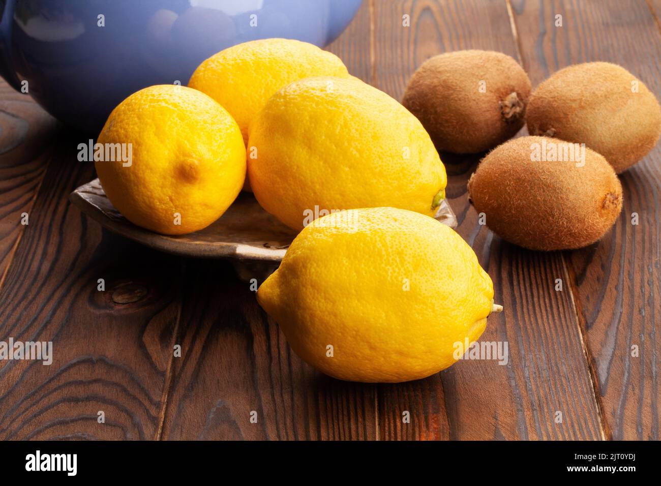 limone su un piatto su sfondo di legno Foto Stock