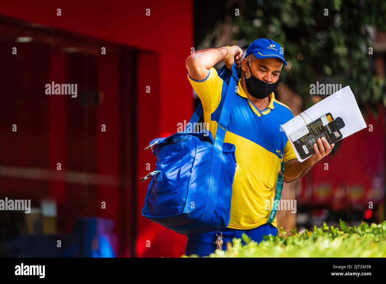 Mail brasiliana uomo con maschera facciale nera a Savassi, Belo Horizonte, Brasile. Foto Stock