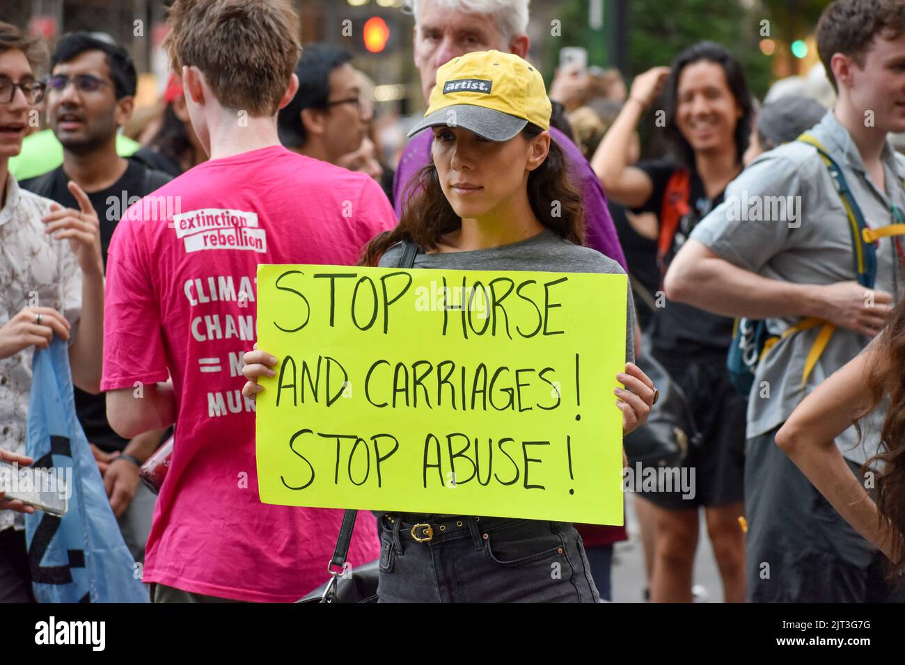 Il partecipante al Rally tiene cartelli anti-abuso di animali di fronte alla fontana Pulitzer a Manhattan per chiedere la fine dell'abuso di carrozza a New York Foto Stock