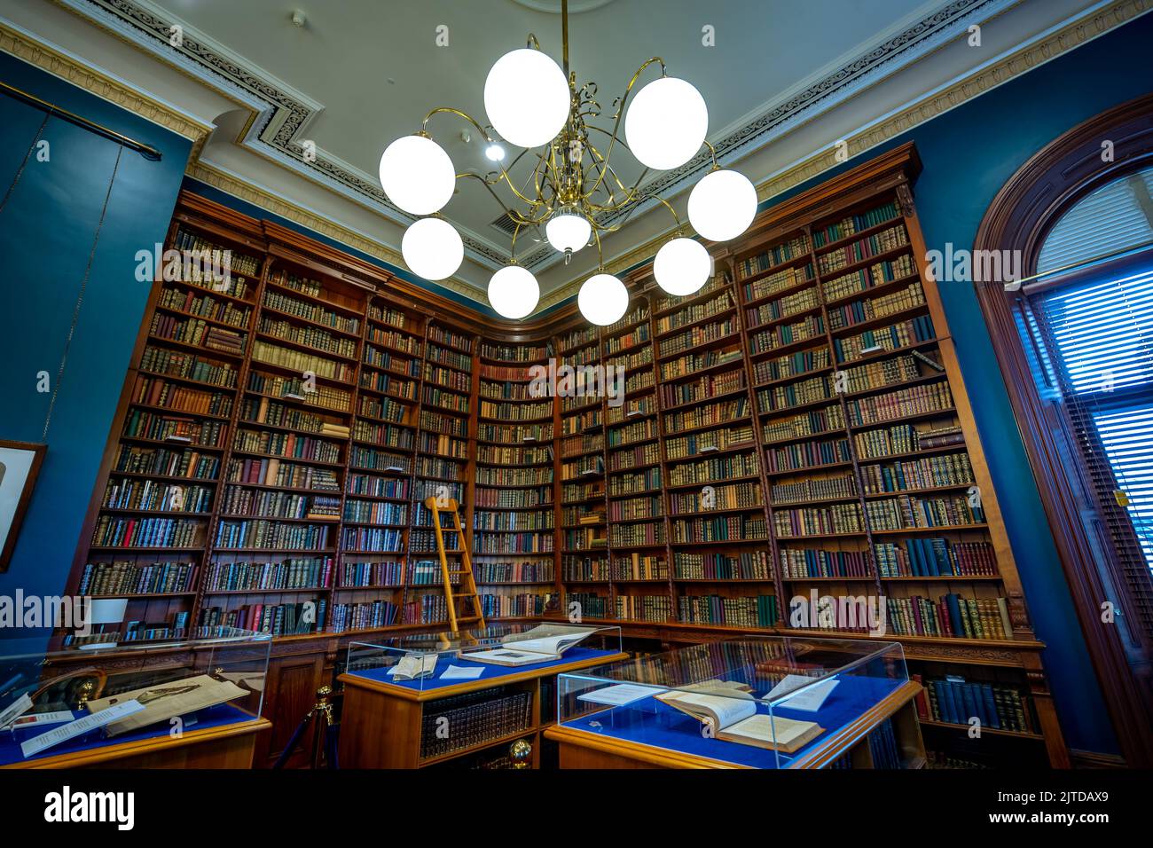 Brisbane, Queensland, Australia - Una scala che risale la libreria con vecchi libri presso la sede del parlamento Foto Stock