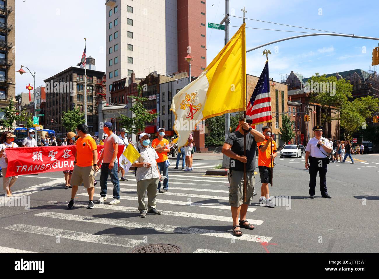 Gli americani cinesi portano la bandiera cattolica alla Festa dell'Assunzione alla Chiesa RC della Trasfigurazione, Manhattan Chinatown, New York, 14 agosto 2022 Foto Stock