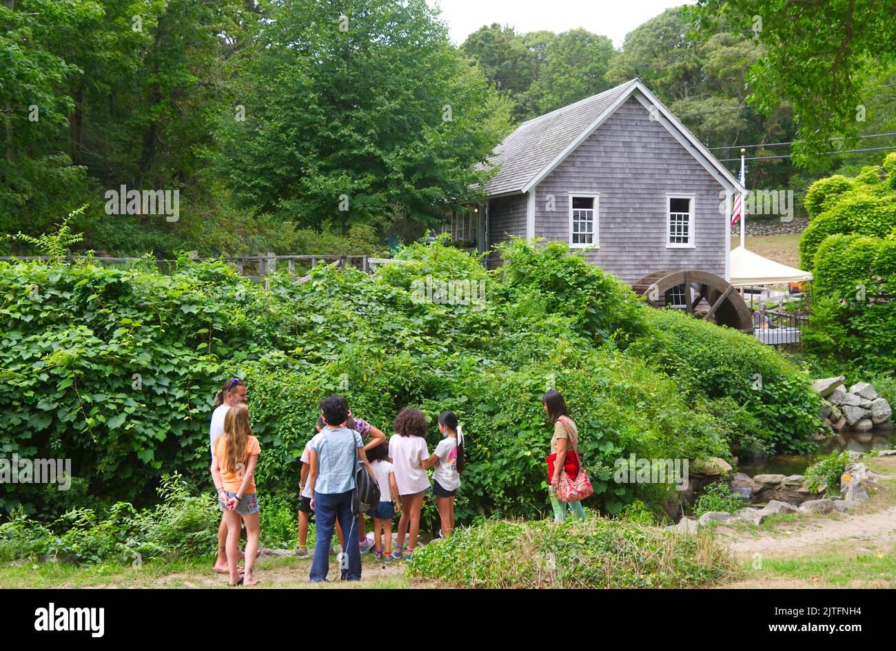Un gruppo studia i terreni dello storico Stony Brook Grist Mill a Brewster, Massachusetts, a Cape Cod. Foto Stock