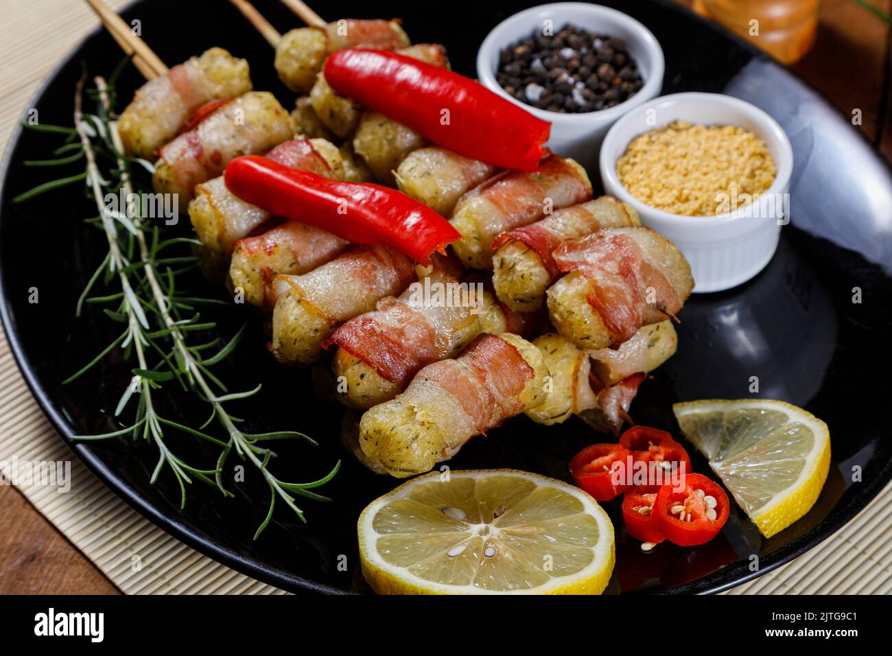 Spiedini di manioca avvolti in pancetta, medaglione di manioca. Foto Stock