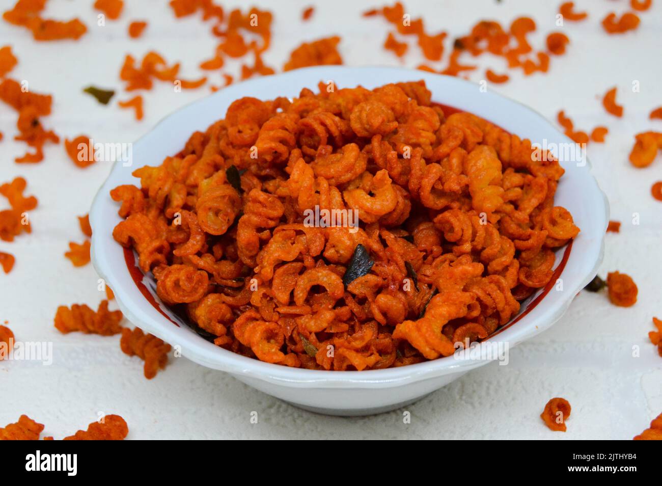 Maccheroni piccanti e saporiti in una ciotola su fondo bianco. I maccheroni secchi hanno una sensazione diversa quando vengono consumati come snack. Foto Stock