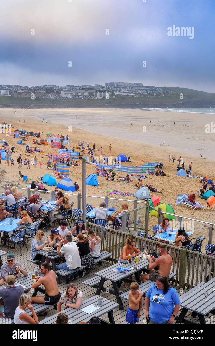 In uno dei giorni più caldi dell'anno nel Regno Unito, i villeggianti di Fistral Beach hanno goduto del caldo sole e della fresca brezza marina di benvenuto Foto Stock