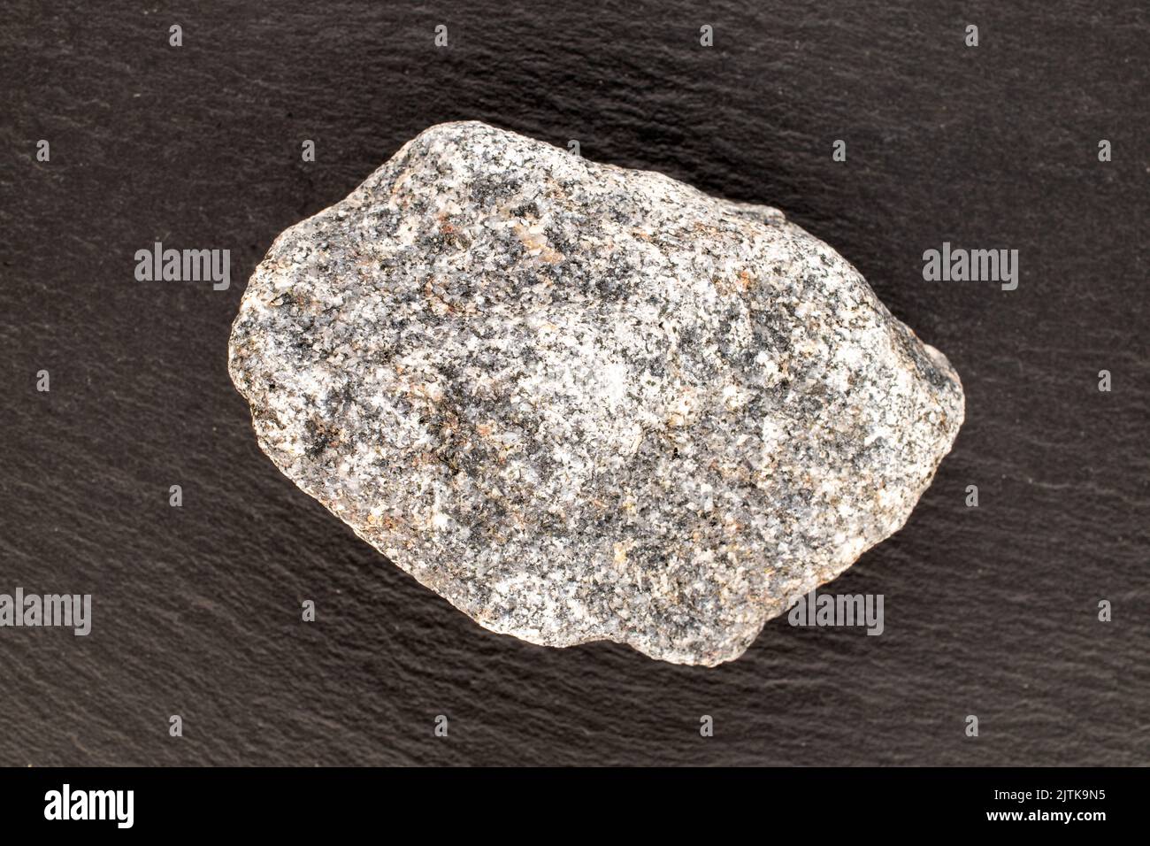 Una pietra di granito su ardesia, primo piano, vista dall'alto. Foto Stock