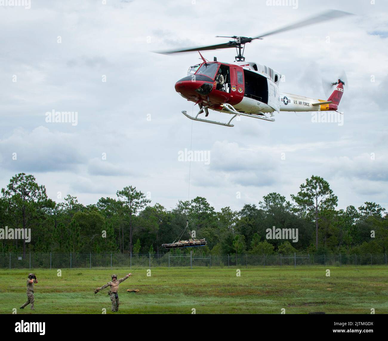 Tactical Air Control Party Airmen del 20th Air Support Operations Squadron aiuta a guidare una cucciolata fino al 413th Flight Test Squadron UH-1 Huey Agosto 23 presso la base dell'aeronautica militare di Eglin, la Fla. Il team TACP di New York, nell'area per la formazione di operazioni speciali, Ha collaborato con l'unico squadrone di prova dello sviluppo ad ala rotante dell'Air Force per vari scenari ed esercizi di estrazione. (STATI UNITI Foto dell'aeronautica/Samuel King Jr.) (STATI UNITI Foto dell'aeronautica/Samuel King Jr.) Foto Stock