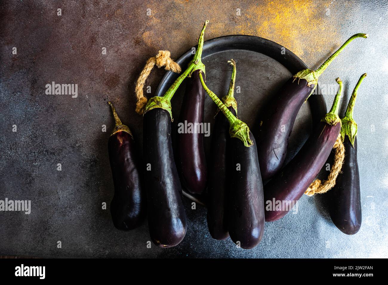 Da sopra melanzane organiche poste su tavola scura Foto Stock