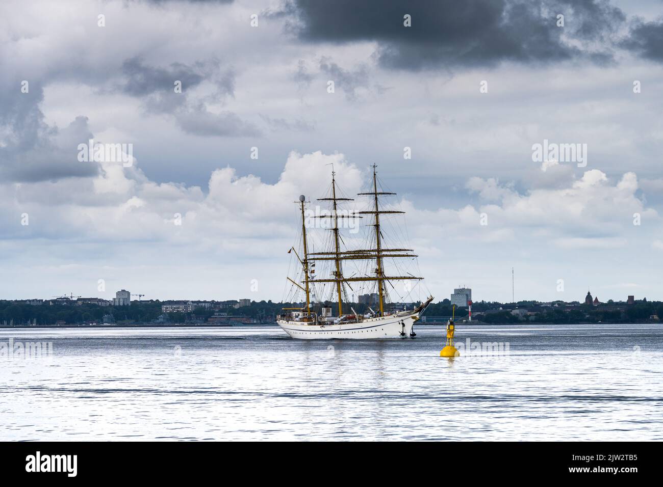 Das Segelschulschiff der Deutschen Marine die Bark Gorch Fock in der Kieler Förde mit dramatischem Himmel in Richtung Ostsee fahrend Foto Stock