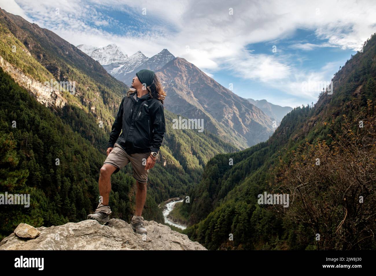 Una guida alpina nepalese che gode del paesaggio nella Valle di Khumbu Foto Stock
