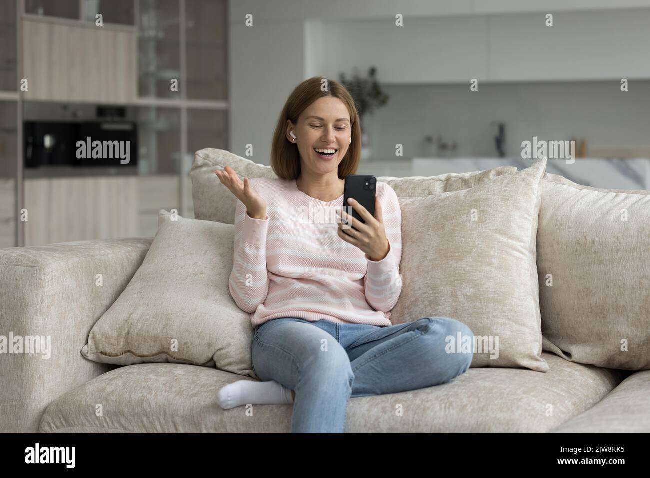 Donna allegra e felice che parla in videochiamata sul telefono cellulare Foto Stock