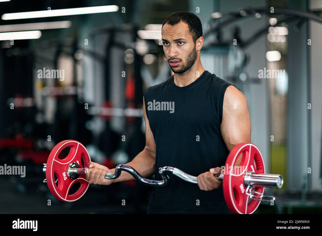 Ritratto di atleta maschile muscoloso nero allenamento con Barbell in palestra Foto Stock