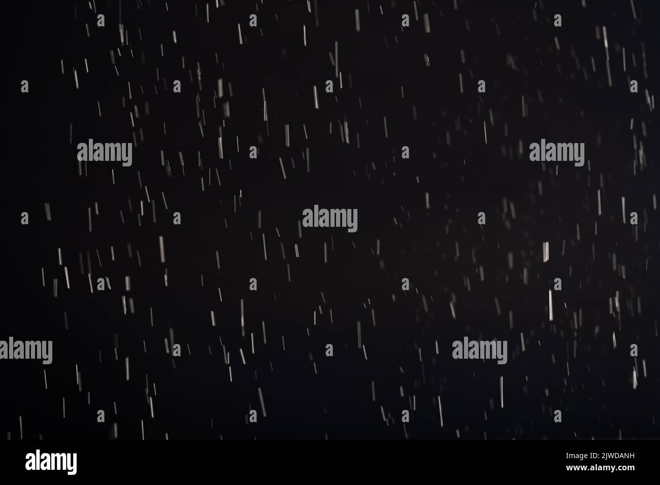 polvere sfondo sfocato bianco fiocchi motivo nero Foto Stock