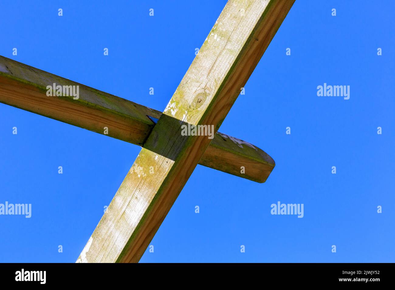 Guardando verso l'alto le travi di legno di Pergola su uno sfondo blu cielo Foto Stock